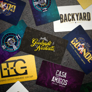 Branded Gift Cards Scattered on Dark Background